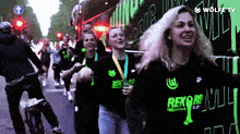 a group of people are walking down a street wearing shirts that say rekord