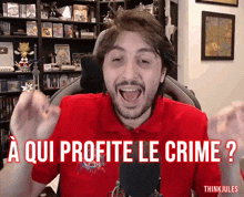 a man in a red shirt with the words " a qui profite le crime " on it