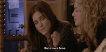 two women sitting next to each other with the words hoes over bros on the bottom