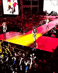 a group of people standing on a stage in front of a crowd with a large screen that says ' nirvana ' on it