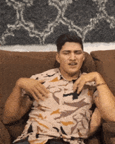 a man sitting on a couch with his eyes closed