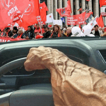 a group of people holding red flags with one that says ' npn ' on it
