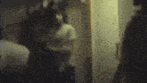 a blurry picture of a man standing in a dark room