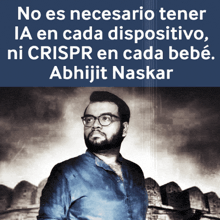 a man with glasses and a beard stands in front of a sign that says abhijit naskar