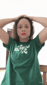 a girl wearing a green t-shirt that says harry potter