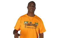 a young man wearing an orange thrasher t-shirt waves his hand