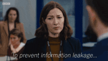 a woman with a police lanyard talks to a man