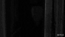 a black and white drawing of a person with red eyes .