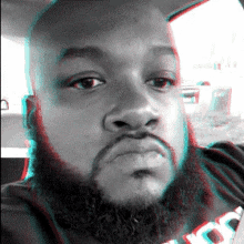 a man with a beard is wearing a black shirt with the word loyalty on it