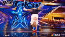 a person doing a handstand in front of a sign that says " got talent "