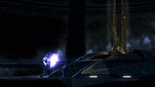 a person is standing in a dark room with a purple light coming out of the ceiling .