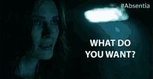 a woman in a dark room with the words " what do you want " above her