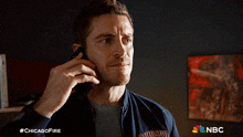 a man talking on a cell phone with the hashtag #chicagofire on the bottom