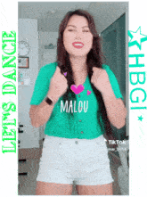 a woman wearing a green shirt that says malou