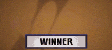 a cartoon character is flying through the air with a sign that says winner .