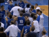 a basketball player with the number 10 on his back is surrounded by other players