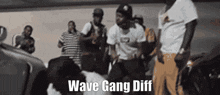 a group of men are dancing in a room and the words wave gang diff are visible