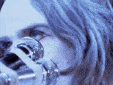 a close up of a woman 's face with a microphone in the foreground