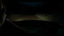 a man is driving a car in the dark and looking at something