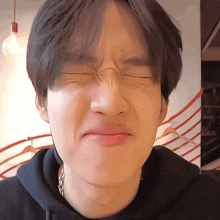 a close up of a person making a funny face with their eyes closed