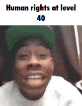 a man wearing a green hat is smiling with the words human rights at level 40 above him
