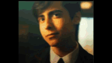 a close up of a man in a suit and tie .