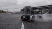 a car with the letter n on the front is drifting