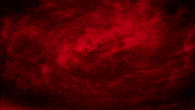 a red background with a glowing object in the middle of it