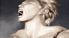 a close up of a woman screaming with her mouth wide open