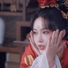 a woman in a red dress with a flower on her forehead