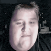 a man with headphones on is making a funny face .