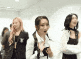 three women are standing next to each other with one wearing a white shirt with a zebra on it