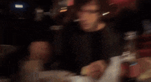 a man sitting at a table with a bottle of coca cola in front of him