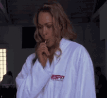 a woman in a white robe with the word espn on the front