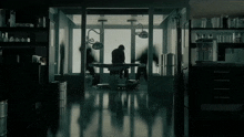 a silhouette of a man in an operating room with a surgical light on