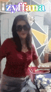 a woman wearing sunglasses and a red shirt with the name zyffana on the bottom
