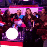a group of people sitting around a table with flags