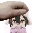 a hand is petting a stuffed animal with bunny ears on its head .