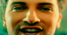 a close up of a man 's face with a smile on it