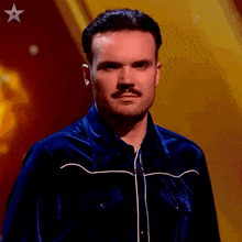 a man with a mustache is wearing a blue shirt with a white trim