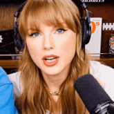 a woman wearing headphones and a shure brand microphone
