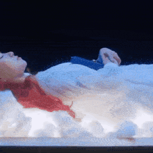 a woman with red hair is laying in a white bed