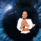 a shirtless man with a tattoo on his arm stands in front of a blue eye