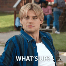 a man in a blue and white striped shirt says what 's up netflix