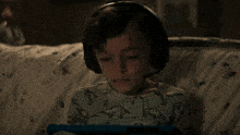 a young boy wearing headphones and a microphone says you 're the monster