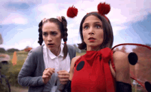 a ladybug and a girl with pigtails are looking at something