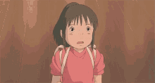 a girl from spirited away is holding a cell phone in her hands .