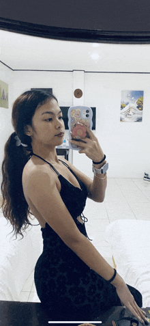 a woman taking a picture of herself in the mirror