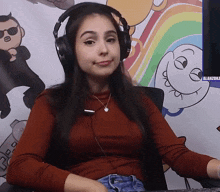 a woman wearing headphones is sitting in front of a computer screen that says alanizuka