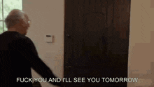 a man is standing in front of a door and says `` fuck you and i 'll see you tomorrow ''